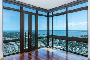 Perched high above the city, this exceptional three bedroom corner residence offers panoramic views of the Long Island Sound and an unparalleled living experience.