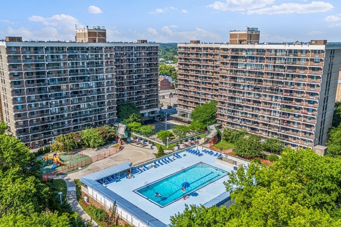 View of urban area with apartment complex and a pool