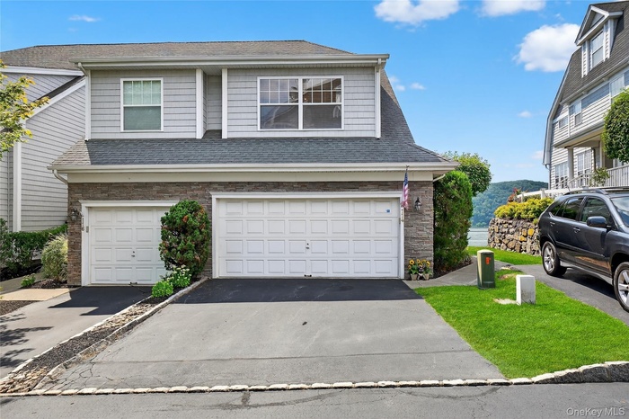 Townhouse -style home with driveway and garage
