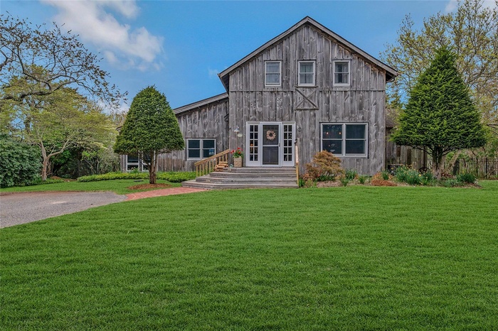 Rear view of property with a yard