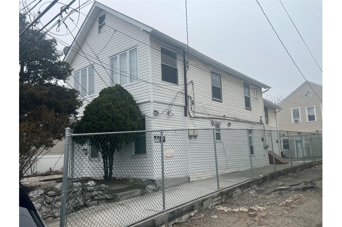 View of property exterior featuring a fenced front yard