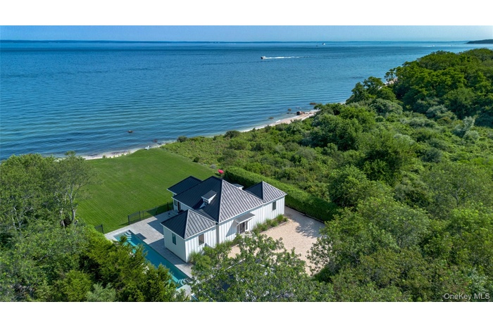 Aerial view of property and surrounding area featuring a large body of water