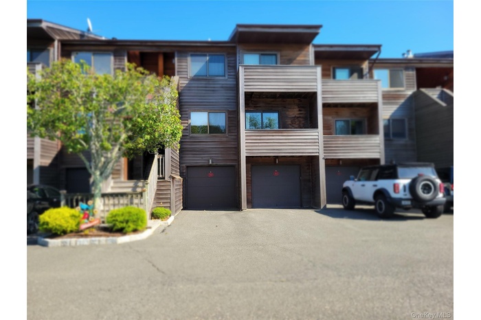View of property with an attached garage and driveway