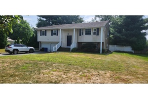 Spacious Custom Hi Ranch featuring Master Bdrm with Full Bath and Walk in Closet, 2 additional Bdrms up, Updated Main Bath, Hardwood Floors on upper level.