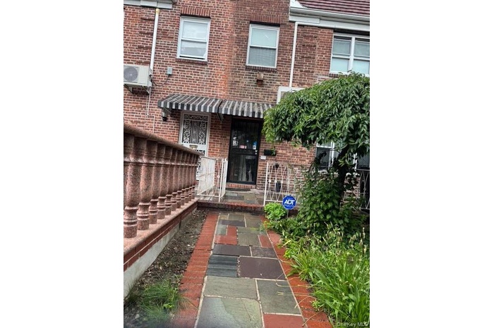 Entrance to property with brick siding