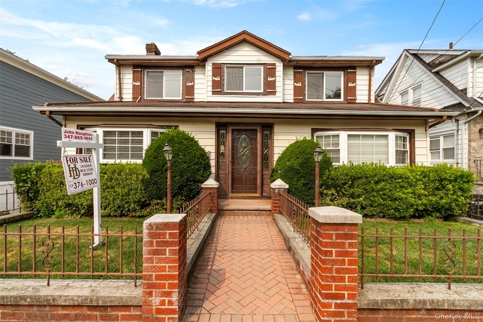 View of front of home featuring a chimney