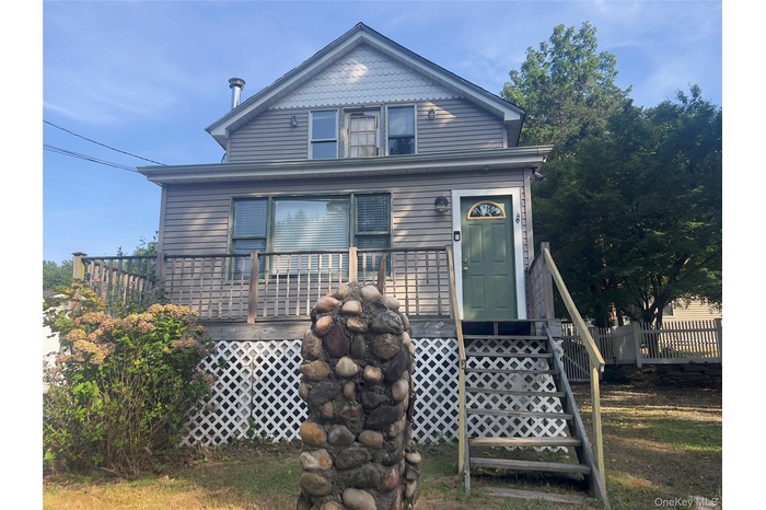 View of front of property featuring a wooden deck