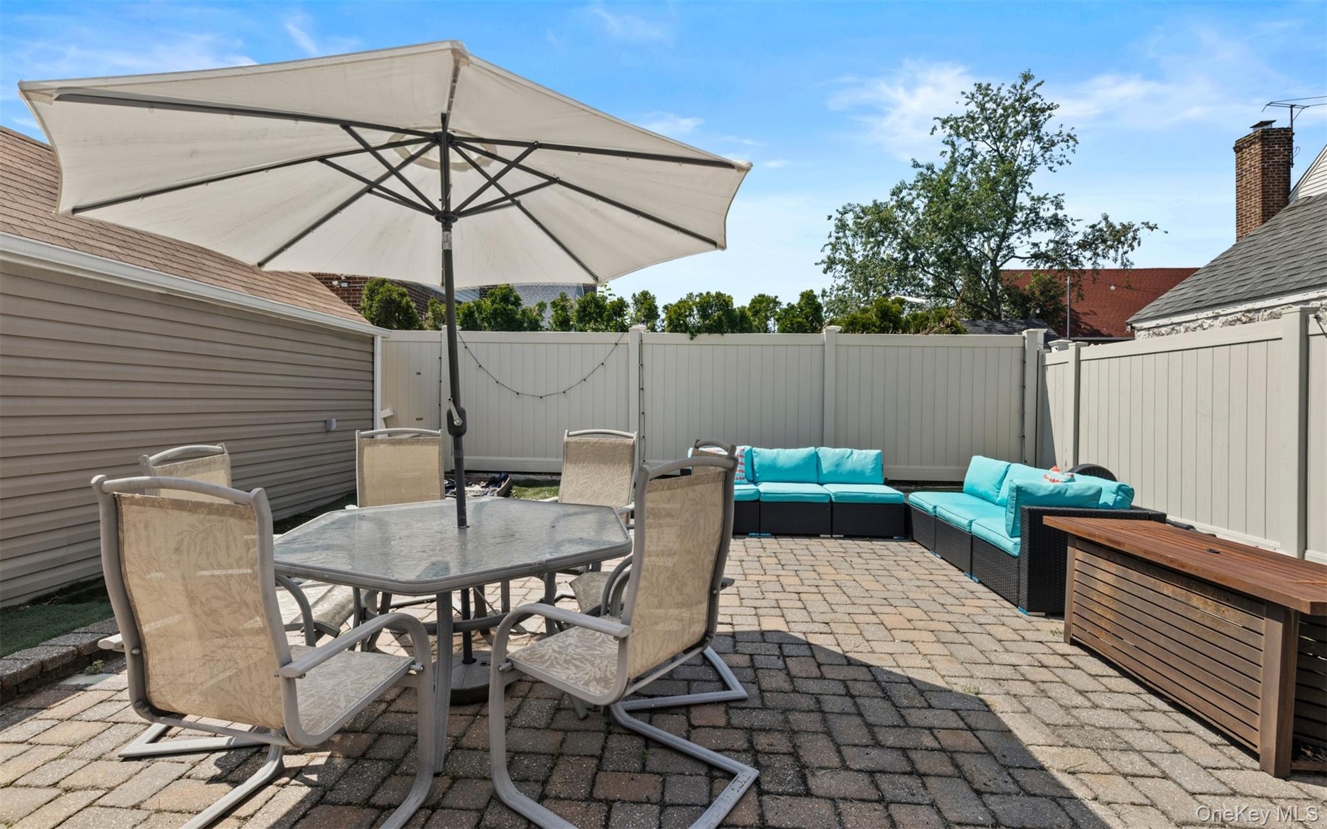 Fenced backyard featuring outdoor dining area, a patio, and outdoor lounge area
