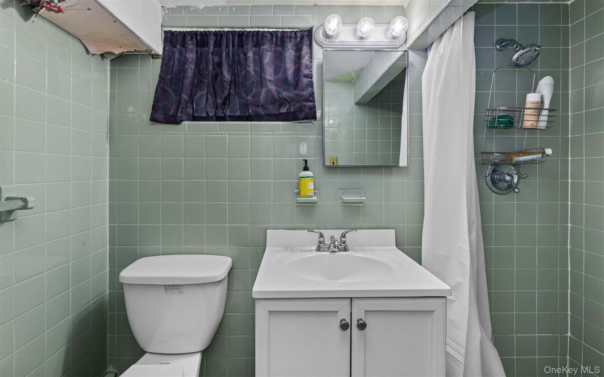 Full bathroom with vanity, tile walls, and a tile shower