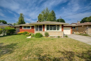 BRICK BUNGALOW ON A QUIET STREET BACKING ONTO BEAUTIFUL LAKESIDE PARK WITH A LAKE AND TRAILS !