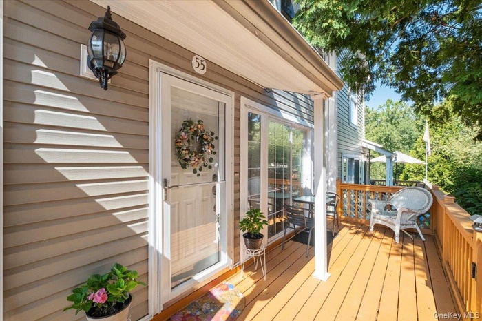 Doorway to property featuring a wooden deck