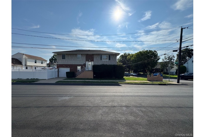 Split foyer home with an attached garage and concrete driveway