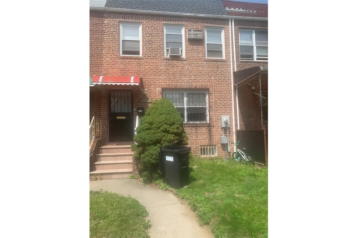 Townhome / multi-family property featuring roof with shingles and brick siding