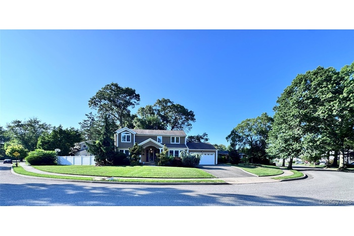 View of front facade featuring asphalt driveway and a garage