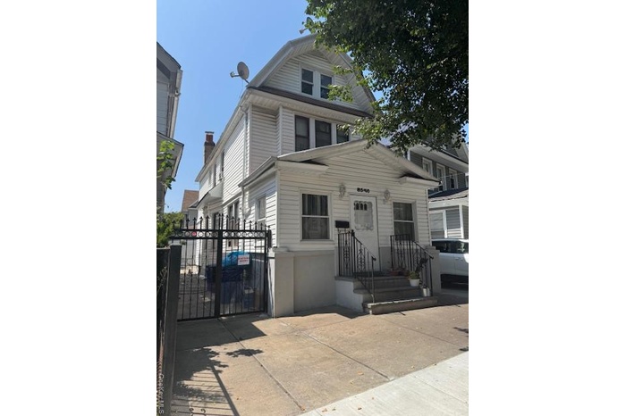 View of front of property with a gate