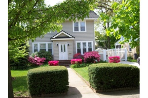 This beautifully maintained colonial style home is nestled on a quiet, tree lined street in the heart of Freeport.