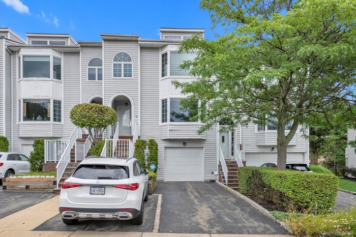 View of front of property with driveway and a garage