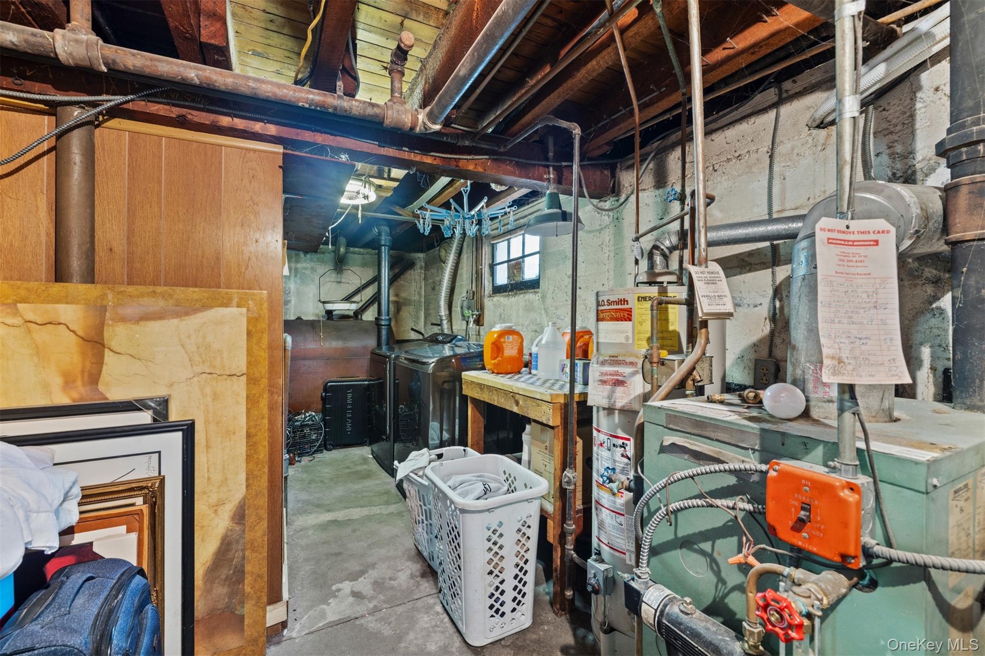 Below grade area with washer / dryer, gas water heater, and a heating unit