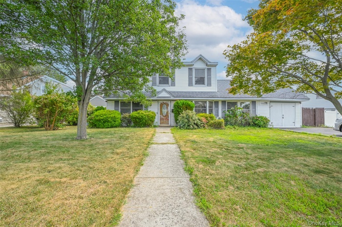 View of front of home with a shingled roof