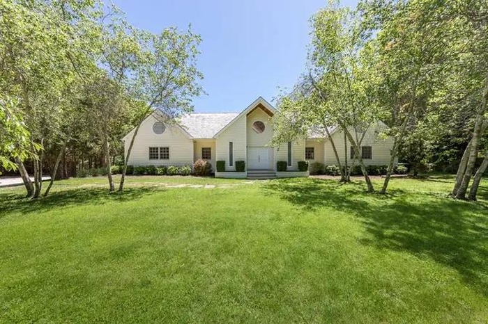 View of front of property with entry steps and a front lawn