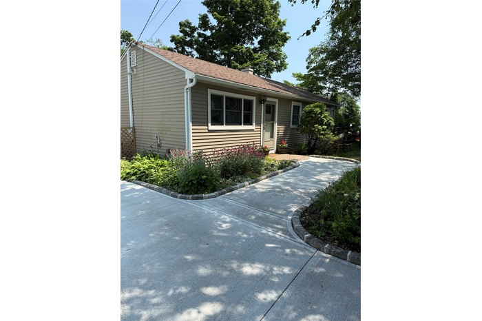View of front of property with roof with shingles