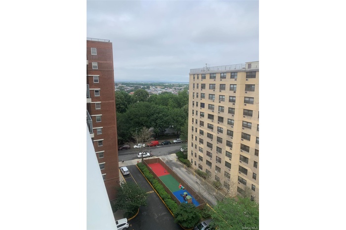 View of building exterior with beautiful views of park and playground