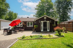 Nestled in the charming waterfront community of Gilford, this beautifully renovated bungalow is a true gem.