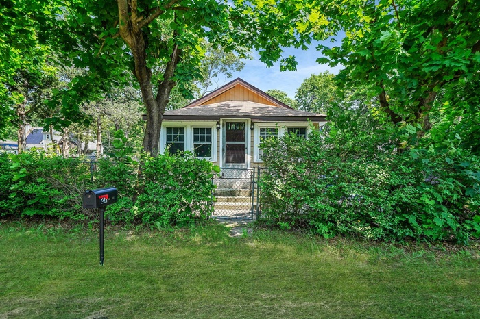 Bungalow-style house featuring a front lawn