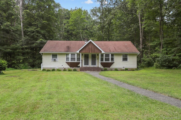 Ranch-style home with a front lawn and entry steps