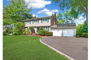 Nestled on a lush Half acre, this elegant Center Hall Colonial blends classic charm with modern comfort.