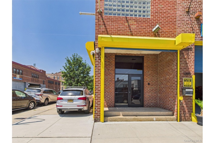 Doorway to property featuring brick siding