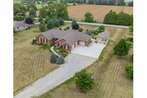 This all brick bungalow sits on just under an acre of beautifully landscaped land, featuring a 3 car attached garage and a fully insulated workshop with hydro, wood stove, and ...