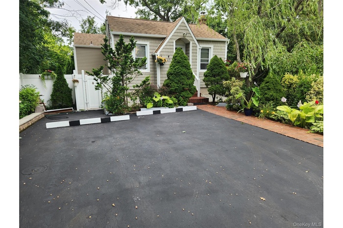 Don't be deceived...plenty of off street parking and lavish landscaping for privacy.