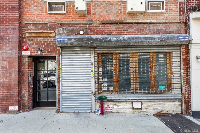 Doorway to property with brick siding and a patio area