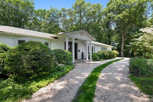 Completely renovated 1964 four bedroom Ranch with central heat gas and AC in Belle Terre on 1 acre.