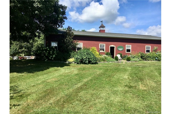 Back of house with a lawn