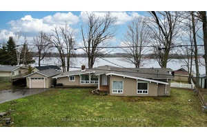 WATERFRONT GEM IN THE HEART OF IT ALL Discover the epitome of lakeside living with this waterfront gem offering 1, 926 square feet of main floor living on virtually one ...