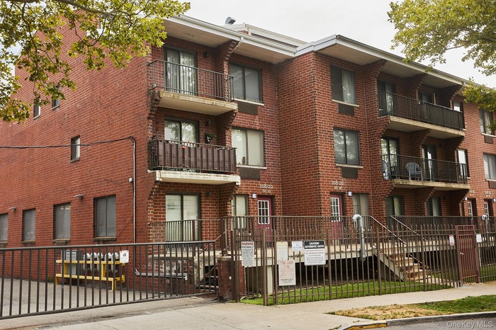 View of building exterior featuring a fenced front yard
