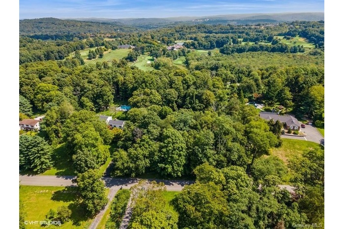 View of property location featuring a forest