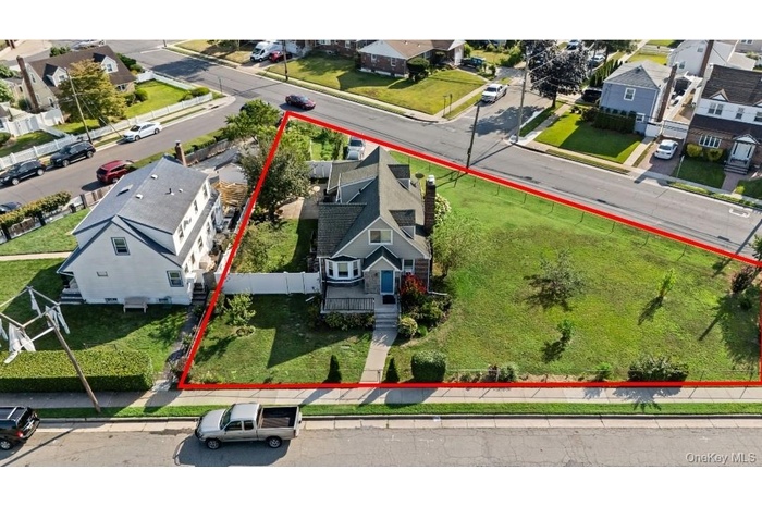 Aerial view of residential area with property parcel outlined
