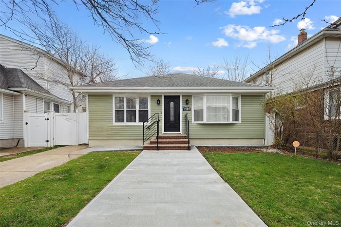 Bungalow featuring a shingled roof, fence, a front lawn, and a gate