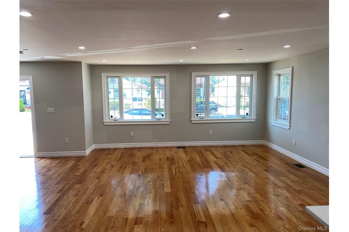 Living room featuring healthy amount of natural light, recessed lighting, and wood finished floors