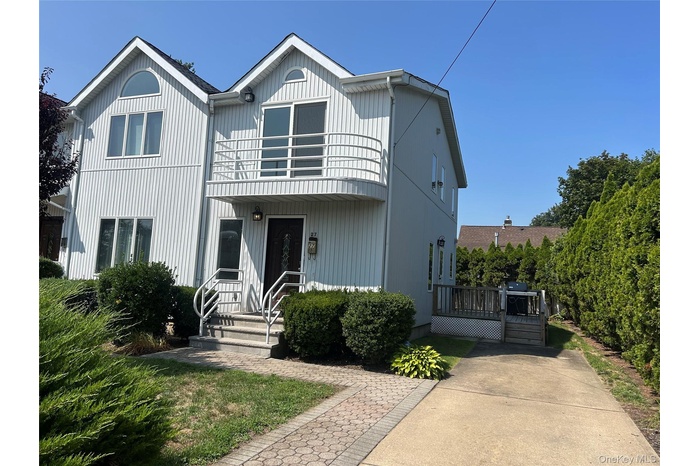 View of front of property with a balcony