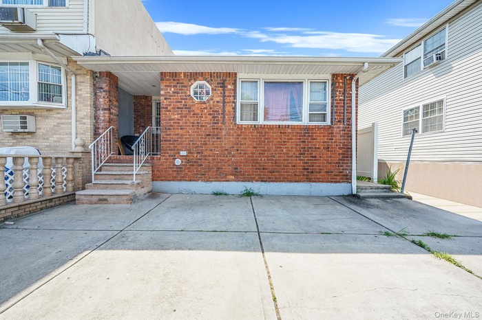 Doorway to property featuring a patio and brick siding