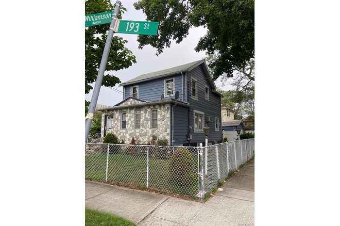View of front of property featuring a fenced front yard and stone siding