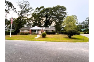 Charming ranch style home featuring 3 bedrooms, 2 bathrooms, and a spacious 2 car garage, perfectly situated on a corner lot along a quiet street.
