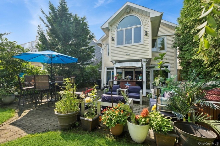 Back of property featuring an outdoor living space and a patio