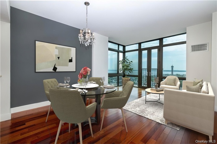 Dining area with expansive windows, dark wood-type flooring, and a chandelier (virtually staged)