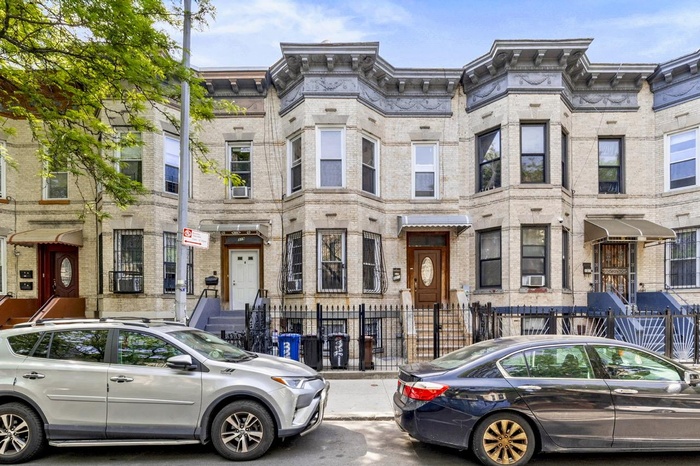 Townhome / multi-family property with a fenced front yard