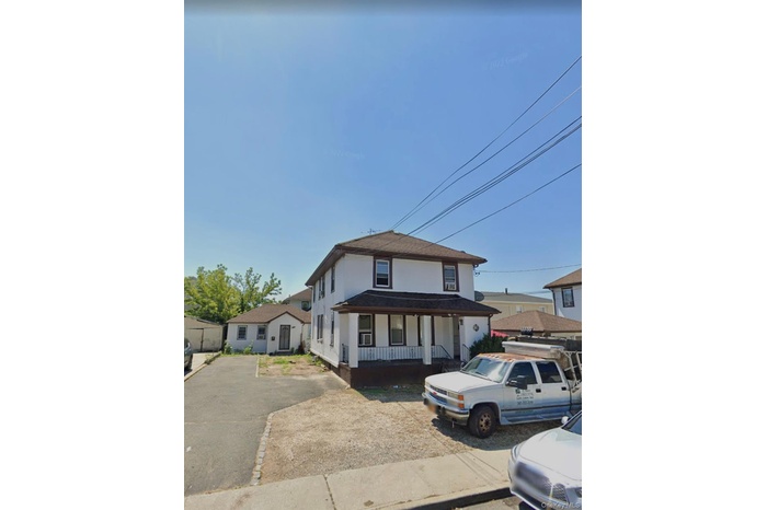 Traditional style home with a porch and stucco siding